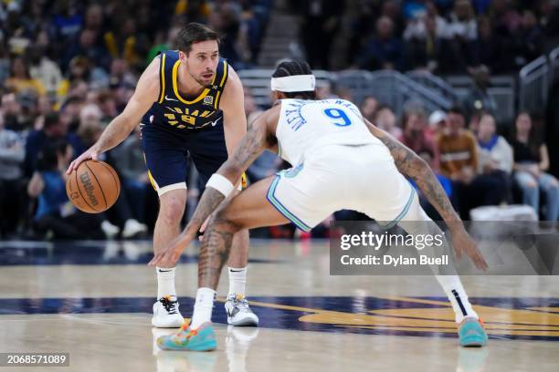 McConnell of the Indiana Pacers dribbles the ball while being guarded by Nickeil Alexander-Walker of the Minnesota Timberwolves in the first quarter...