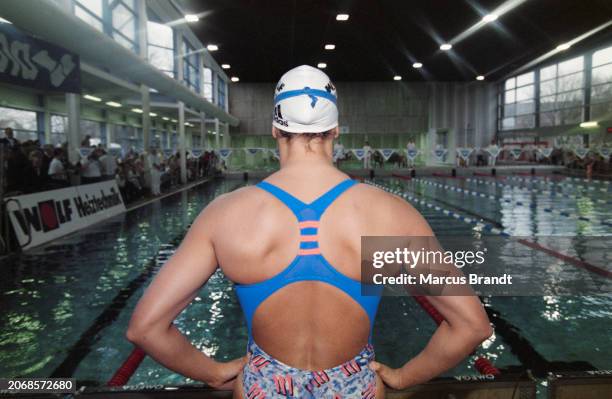 Rear view of German swimmer Sandra Volker, her hands on her hips, at the German Team Championship in Hamburg, Germany, January 1997.