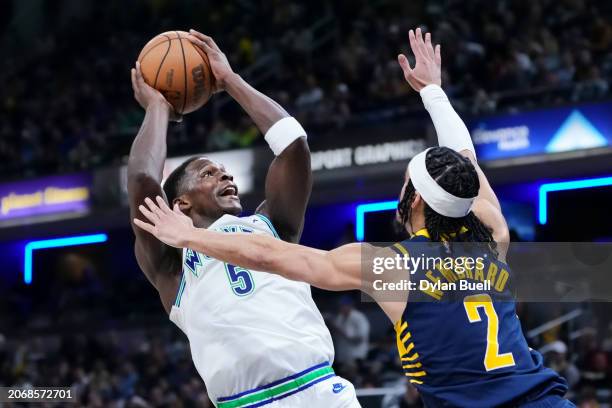 Anthony Edwards of the Minnesota Timberwolves attempts a shot while being guarded by Andrew Nembhard of the Indiana Pacers in the third quarter at...