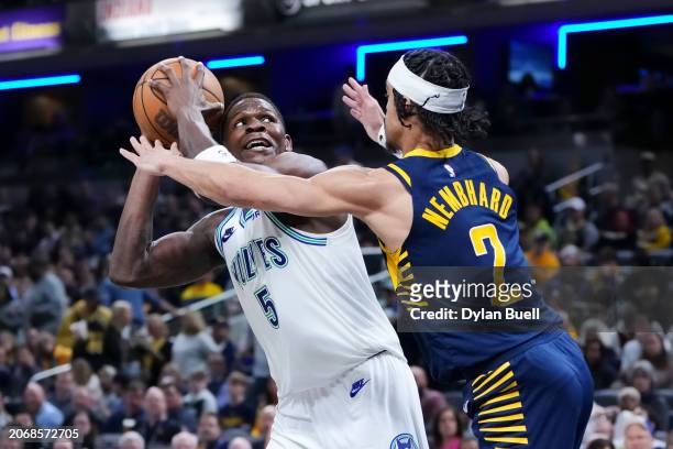 Anthony Edwards of the Minnesota Timberwolves attempts a shot while being guarded by Andrew Nembhard of the Indiana Pacers in the third quarter at...