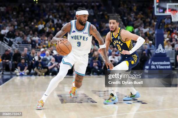 Nickeil Alexander-Walker of the Minnesota Timberwolves dribbles the ball while being guarded by Tyrese Haliburton of the Indiana Pacers in the third...