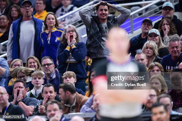 Fans react to a foul call during the game between the Minnesota Timberwolves and the Indiana Pacers at Gainbridge Fieldhouse on March 07, 2024 in...