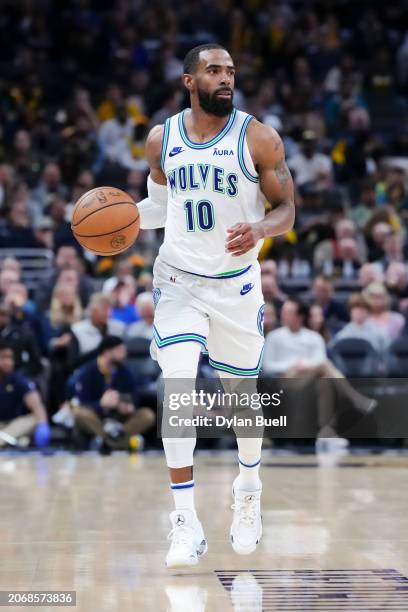 Mike Conley of the Minnesota Timberwolves dribbles the ball in the fourth quarter against the Indiana Pacers at Gainbridge Fieldhouse on March 07,...