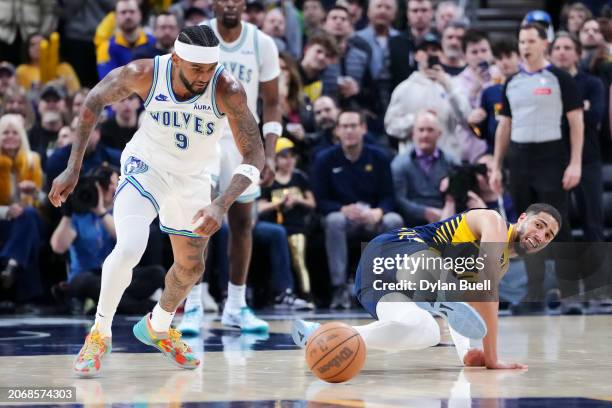 Nickeil Alexander-Walker of the Minnesota Timberwolves steals the ball from Tyrese Haliburton of the Indiana Pacers in the third quarter at...