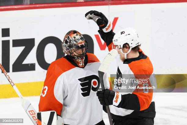 Travis Sanheim congratulates goaltender Samuel Ersson of the Philadelphia Flyers after the 2-1 win against the Florida Panthers at the Amerant Bank...