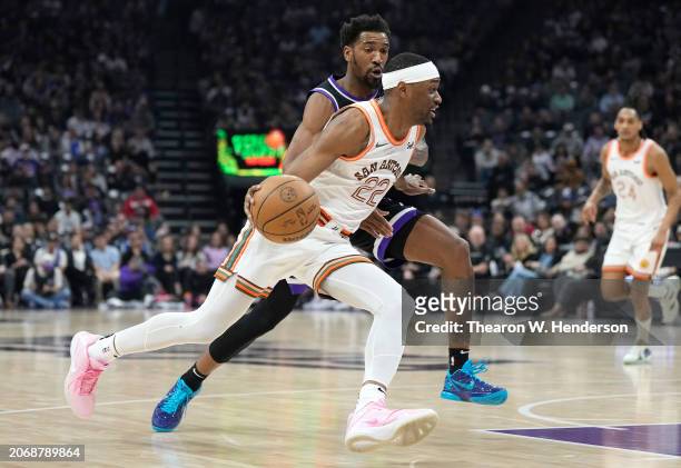Malaki Branham of the San Antonio Spurs drives to the basket on Malik Monk of the Sacramento Kings during the first quarter of an NBA basketball game...