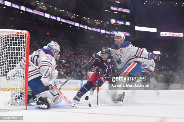 Goaltender Calvin Pickard of the Edmonton Oilers blocks a shot attempt by Johnny Gaudreau of the Columbus Blue Jackets during the first period of a...