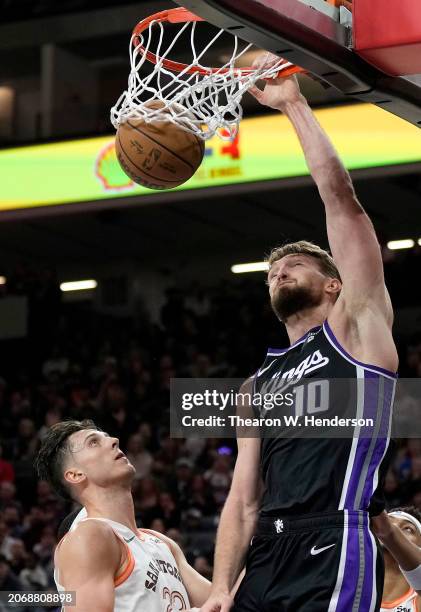 Domantas Sabonis of the Sacramento Kings slam dunks against the San Antonio Spurs during the fourth quarter of an NBA basketball game at Golden 1...