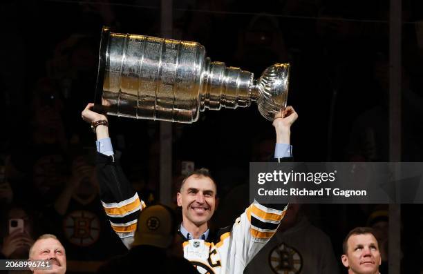 Zdeno Chara, a former Boston Bruin captain and player and member of the 2011 Stanley Cup champion team raises the Stanley Cup as he takes part in an...