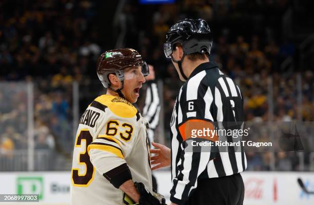 Brad Marchand of the Boston Bruins talks to referee Francis Charron during a break in the action during the first period during a game against the...