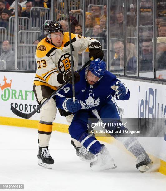 Auston Matthews of the Toronto Maple Leafs is checked by Charlie McAvoy of the Boston Bruins during the second period at the TD Garden on March 7,...