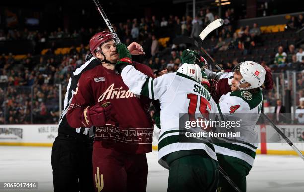 Josh Brown of the Arizona Coyotes battles with Mason Shaw of the Minnesota Wild at Mullett Arena on March 07, 2024 in Tempe, Arizona.