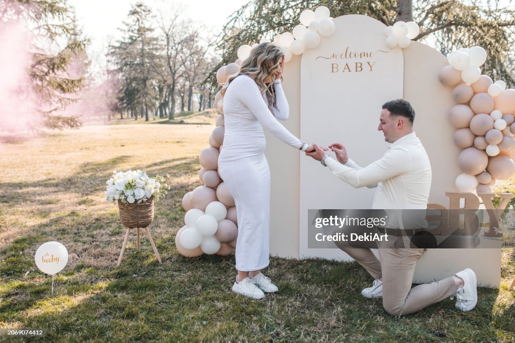 A man proposes to his pregnant girlfriend and puts an engagement ring on her hand