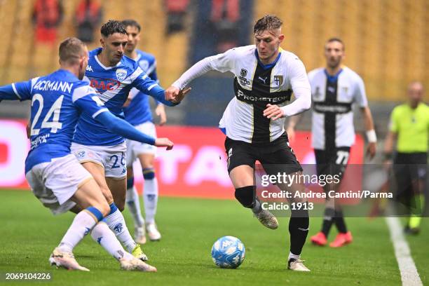 Adrian Benedyczak fight for the possession during Serie B match between Parma and Brescia at Stadio Ennio Tardini on March 08, 2024 in Parma, Italy.