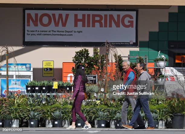 Home Depot customers walk by a posted now hiring sign on March 08, 2024 in San Rafael, California. According to a report from the Bureau of Labor...