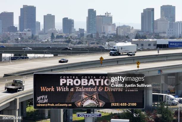 In an aerial view, a billboard advertising job openings with the Contra Costa County probation department is posted next to a freeway on March 08,...