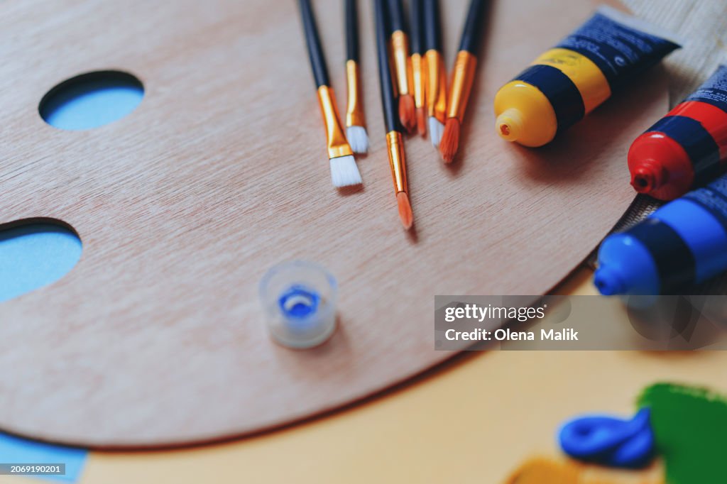 Paint brushes and paints on a palette