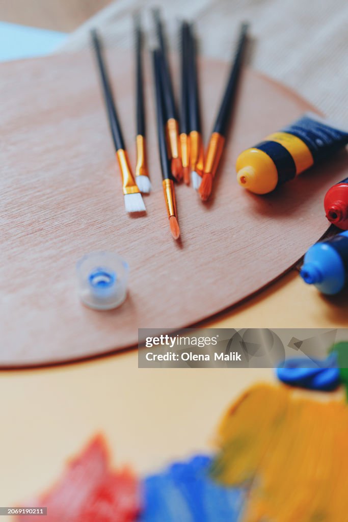 Paint brushes and paints on a palette