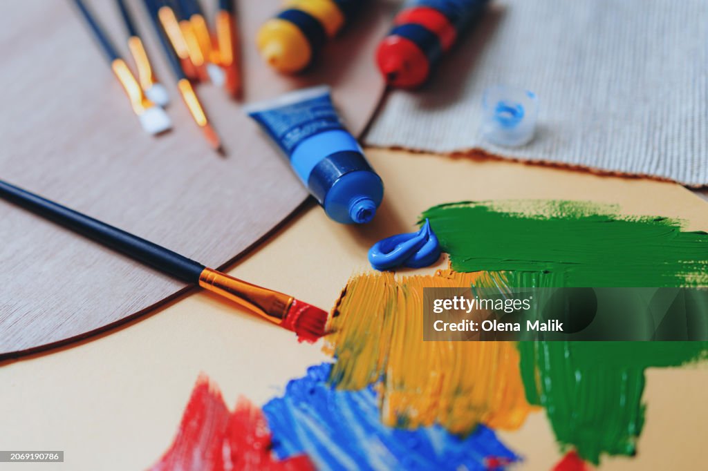 Paint brushes and paints on a palette