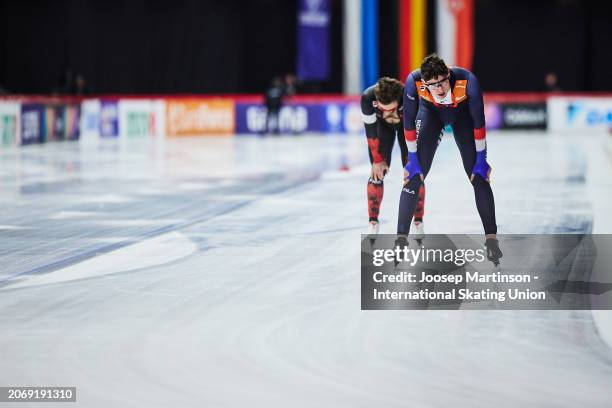 Jenning De Boo of Netherlands and Laurent Dubreuil of Canada look dejected as Zhongyan Ning of China wins the Men's Sprint overall classification at...