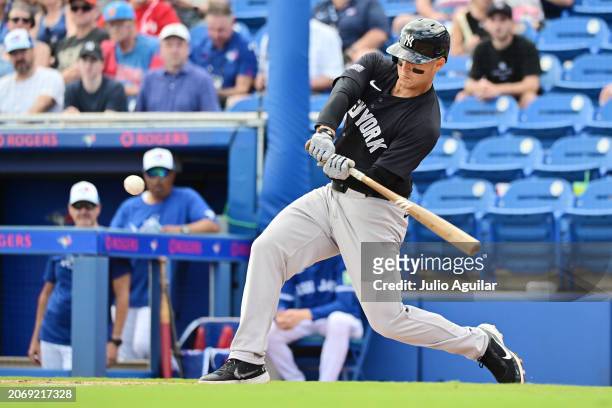 Anthony Rizzo of the New York Yankees looks to hit a single in the fourth inning against the Toronto Blue Jays during a 2024 Grapefruit League Spring...