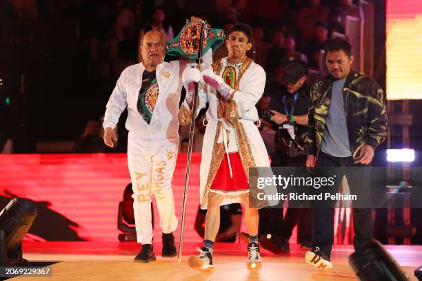 Rey Vargas enters the arena to begin his ring-walk beside a member of coaching staff and Manny Pacquiao ahead of on the Knockout Chaos boxing card at...