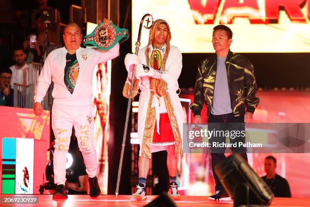 Rey Vargas enters the arena to begin his ring-walk beside a member of coaching staff and Manny Pacquiao ahead of the WBC World Featherweight title...