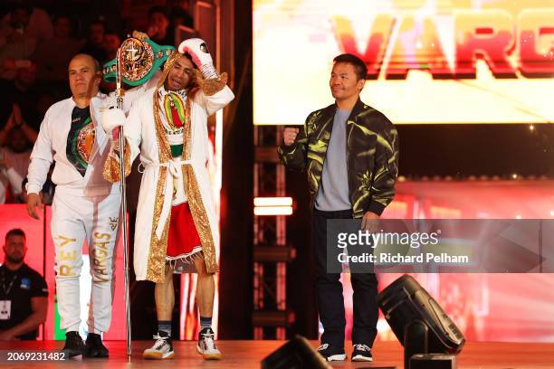 Manny Pacquiao gestures beside Rey Vargas as he enters the arena to begin his ring-walk beside a member of coaching staff ahead of the WBC World...