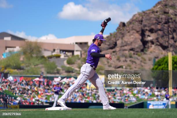 Kris Bryant of the Colorado Rockies fields the ball for an out in the first inning during a spring training game against the Los Angeles Angels at...