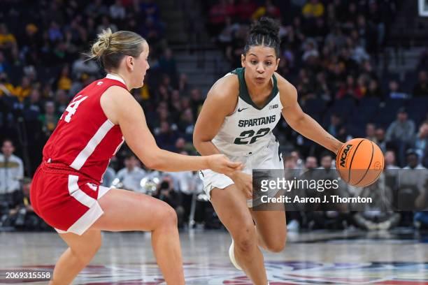 Moira Joiner of the Michigan State Spartans dribbles the ball against Callin Hake of the Nebraska Cornhuskers during the first half of a Big Ten...