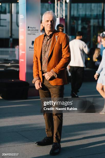 Paul wears a burn orange blazer with a brown paisley shirt and retro patterned tailored pants Melbourne Fashion Festival 2024 on March 08, 2024 in...