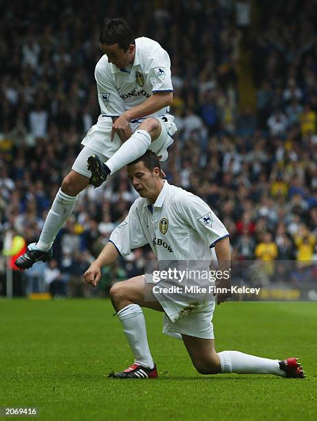 Gary Kelly of Leeds United jumps over team-mate Ian Harte after he scores the opening goal of the match during the FA Barclaycard Premiership match...