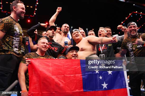 Joseph Parker celebrates victory over Zhilei Zhang with his coaching team whilst holding a Samoan flag following the WBO Interim World Heavyweight...