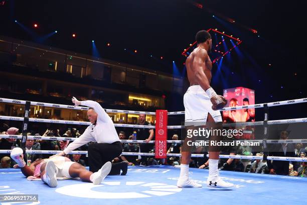 Francis Ngannou is knocked down for the third time as Referee Ricky Gonzalez stops the fight and checks on him during the Heavyweight fight between...