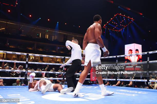 Francis Ngannou is knocked down for the third time as Referee Ricky Gonzalez stops the fight during the Heavyweight fight between Anthony Joshua and...