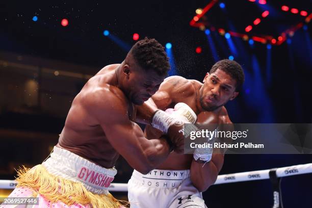 Anthony Joshua punches Francis Ngannou during the Heavyweight fight between Anthony Joshua and Francis Ngannou on the Knockout Chaos boxing card at...