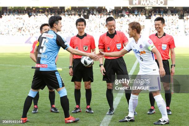 Captains Shogo Taniguchi of Kawasaki Frontale and Toshihiro Aoyama of Sanfrecce Hiroshima shake hands at the coin toss prior to the J.League J1 match...