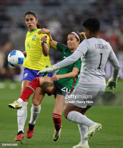 Mayra Pelayo of Mexico attempts a shot between Rafaelle and Luciana of Brazil in a 3-0 Brazil win during the Semifinals 2024 Concacaf W Gold Cup at...