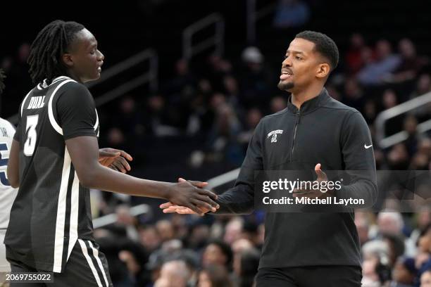 Head coach KIm English of the Providence Friars celebrates a shot with Garwey Dual during a college basketball game against the Georgetown Hoyas at...