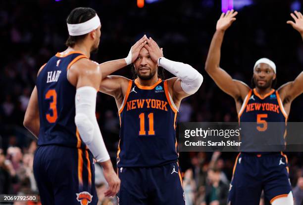 Jalen Brunson and Precious Achiuwa of the New York Knicks react with Josh Hart during the second half against the Orlando Magic at Madison Square...
