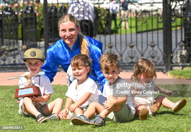 Jamie Kah poses with the late Dean Holland's children after receiving the Dean Holland trophy after riding Cylinder to win Race 5, the Yulong...