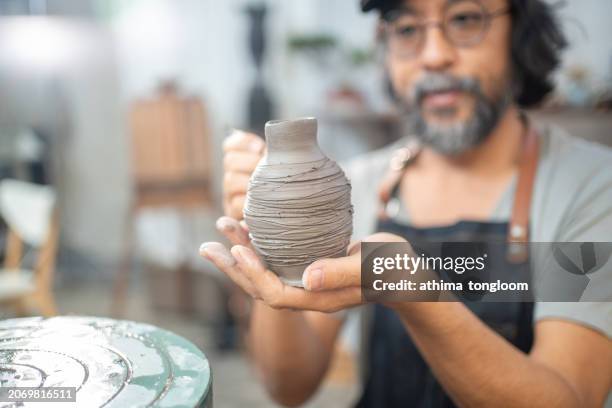 a pottery working at his pottery studio. - east asian works of art specialist stock pictures, royalty-free photos & images