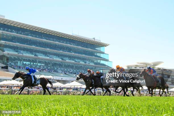 Jamie Kah riding Cylinder defeats Opie Bosson riding Imperatriz and The Astrologist in Race 5, the Yulong Newmarket Handicap, during Melbourne Racing...