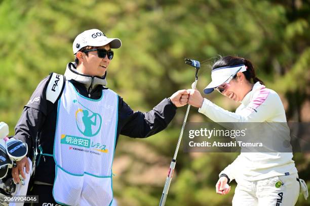 Haruka Amamoto of Japan fist bumps with her caddie after saving the par on the 10th green during the third round of MEIJI YASUDA LIFE INSURANCE...