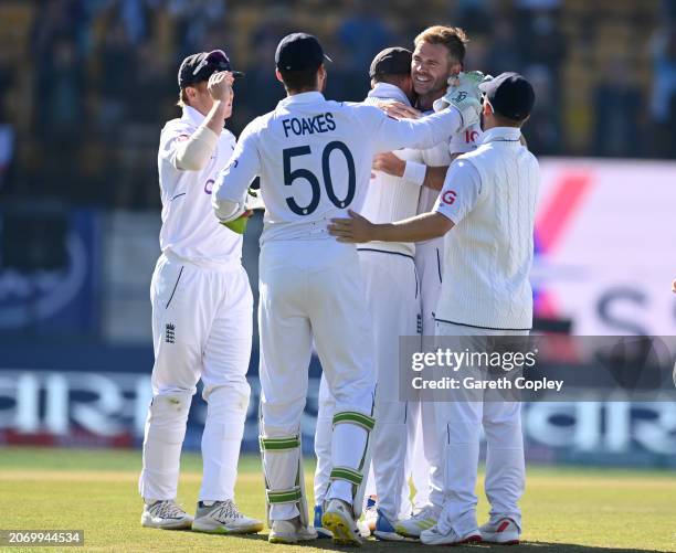 James Anderson of England celebrates with teammates after dismissing Kuldeep Yadav of India to claim his 700th test wicket during day three of the...