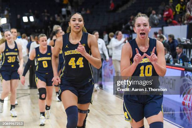 Cameron Williams and Jordan Hobbs of the Michigan Wolverines walk off the court after winning a Big Ten Women's Basketball Tournament quarter finals...