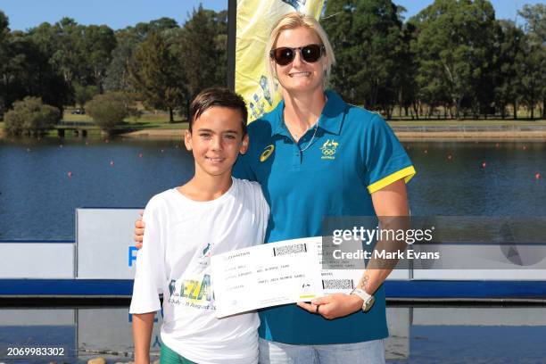Alyssa Bull is presented with her boarding pass by junior canoeist Koa Brodie during the Australian 2024 Paris Olympic Games Canoe Sprint Squad...