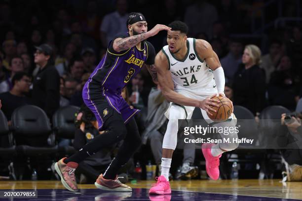 Anthony Davis of the Los Angeles Lakers defends against the dribble of Giannis Antetokounmpo of the Milwaukee Bucks during the second half of a game...