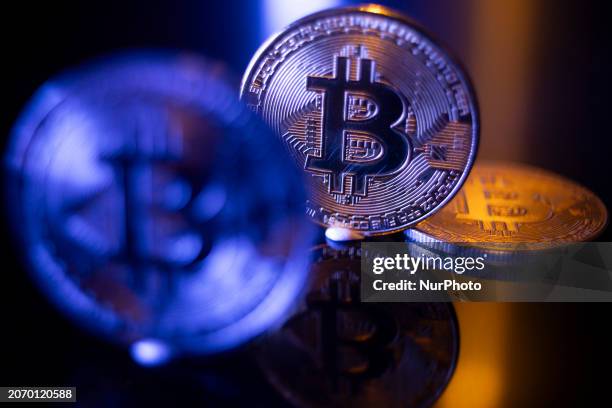 Bitcoins golden physical coin illustration on dark black background with reflection and vibrant color light illumination. Visual representations of...