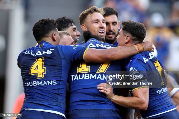 Bryce Cartwright of the Eels celebrates celebrates with team mates after scoring a try during the round one NRL match between Parramatta Eels and...